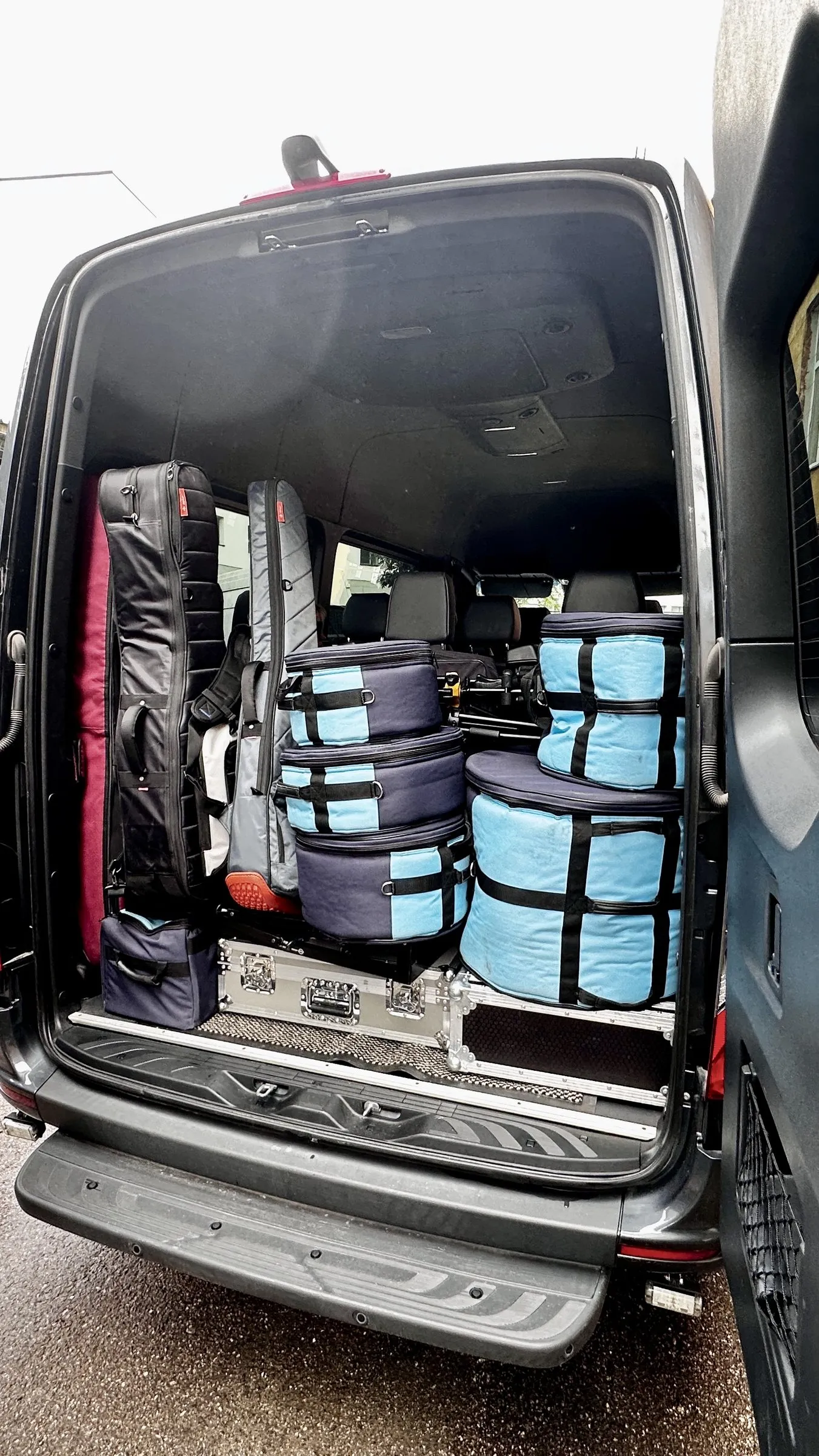 Touring luggage stacked in the Sprinter rear compartment