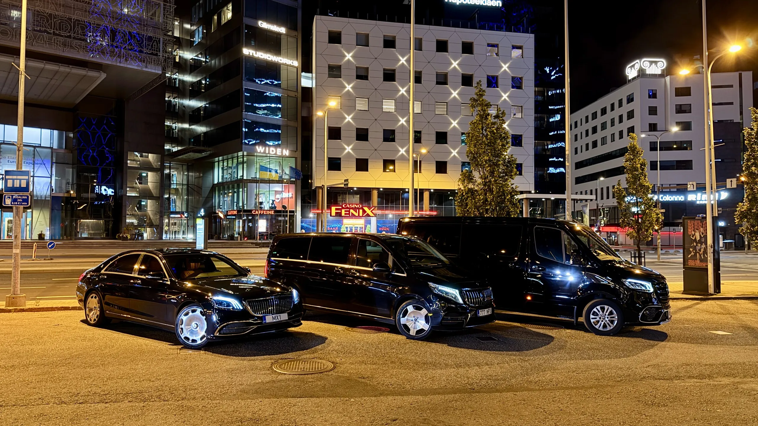 SoloTransfer fleet at night in Tallinn — 24/7 dispatch across Estonia and the Baltics